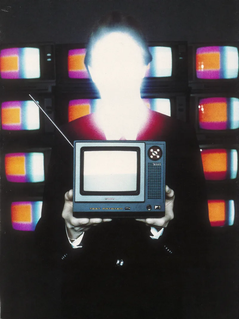 Promo photograph of Test Pattern: a figure whose face is obscured by the glow of a television test card
